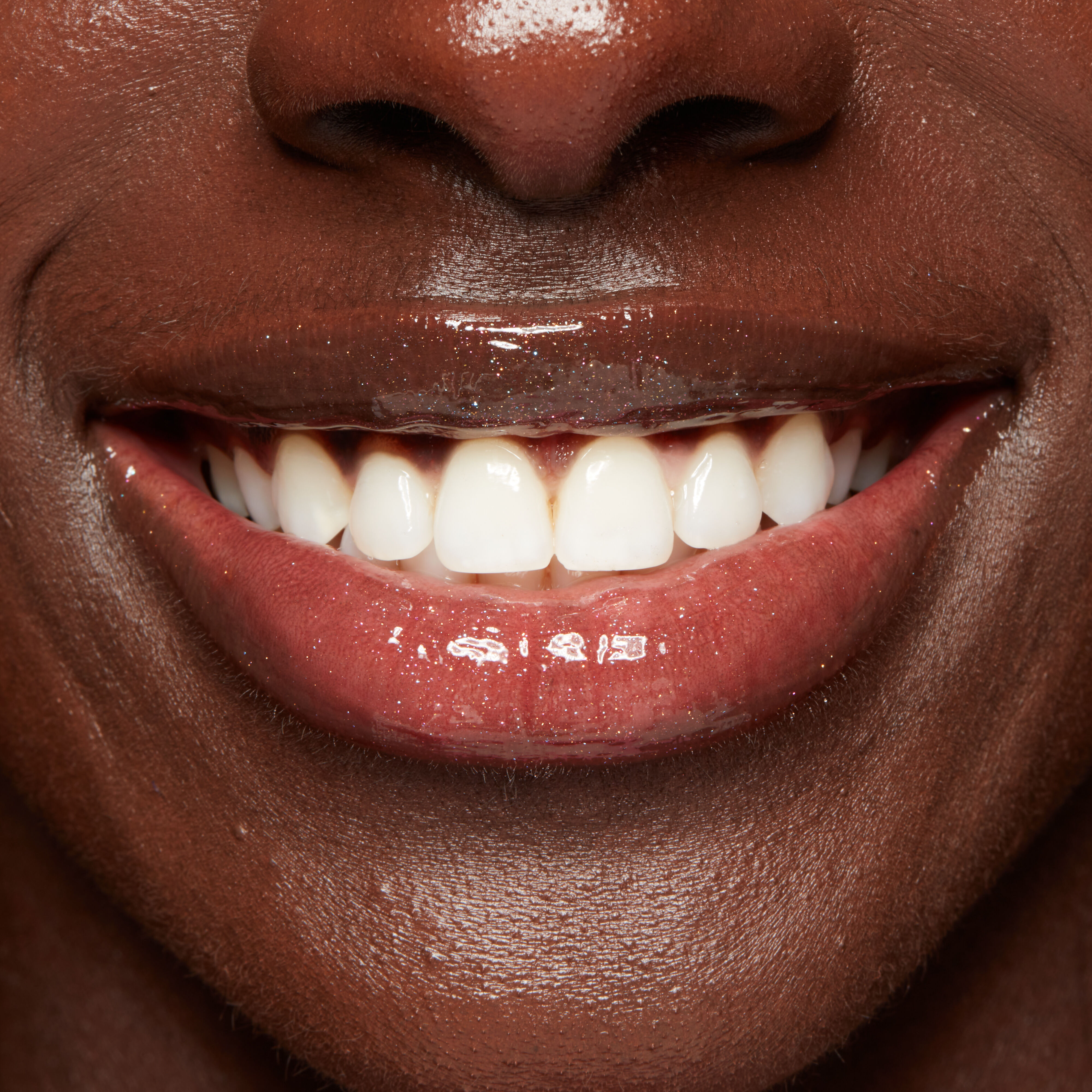 Duck Plump Lip Plumping Gloss on closeup smiling lips
