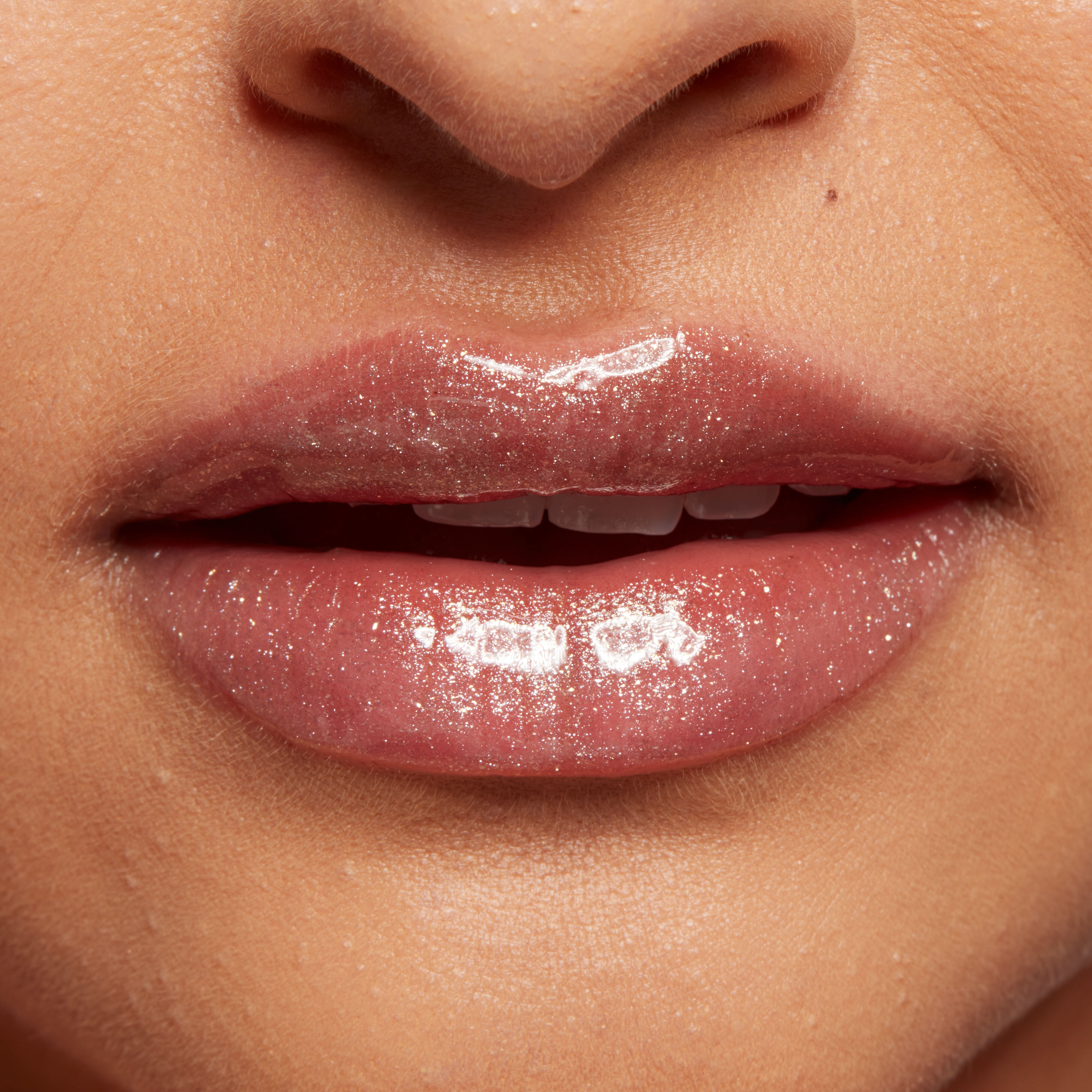 Duck Plump Lip Plumping Gloss on closeup front view of puckered lips