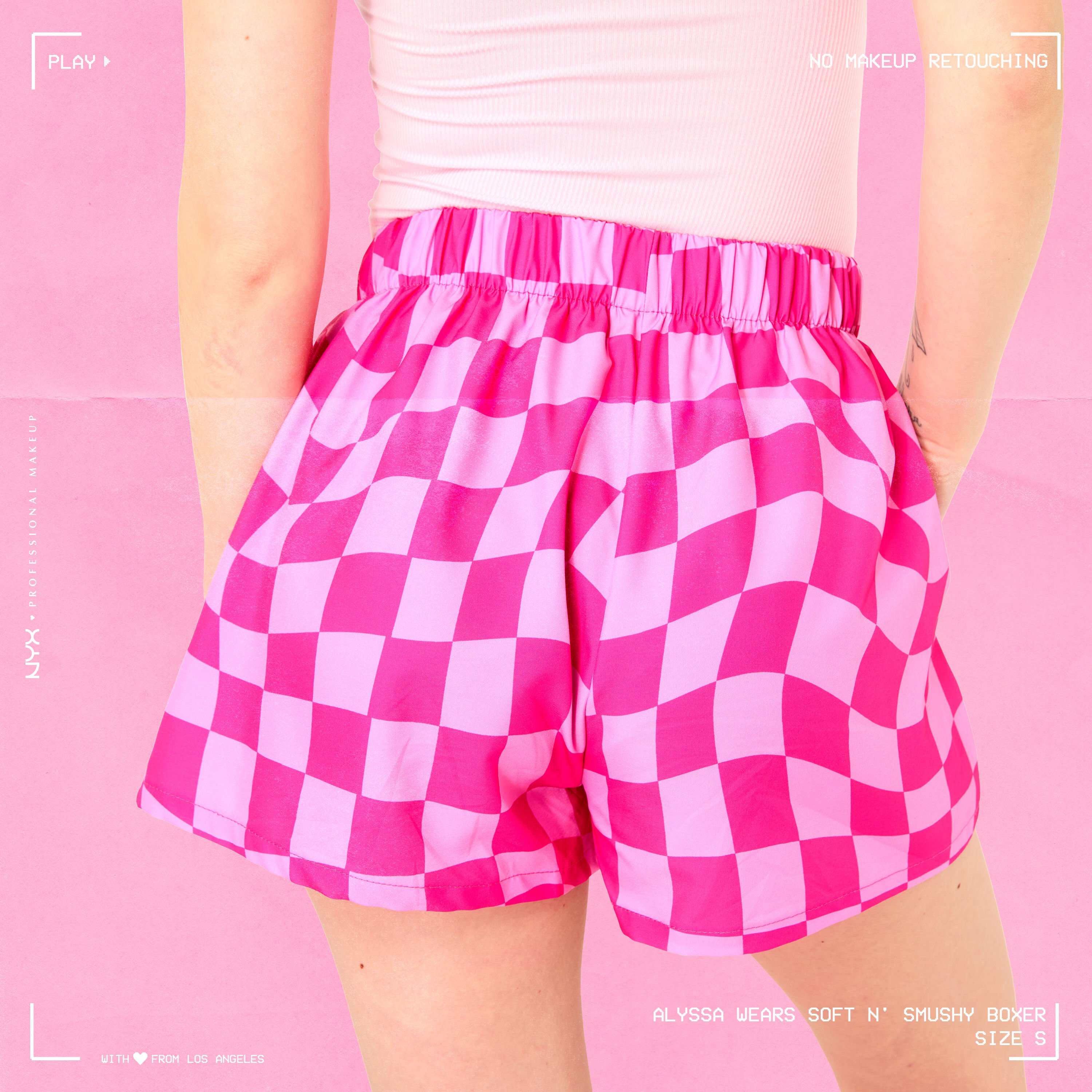 Model wearing Soft n' Smushy Pink Checker Print Boxers in a size small, showing the back of the boxers