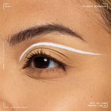 Close-up of an eye wearing NYX Professional Makeup Party Animals Epic Ink Liner in Phantom Lines as a crisp white graphic eyeliner design.