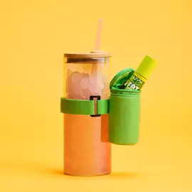 Green Lip Gloss Pouch attached to iced orange drink with straw lid
