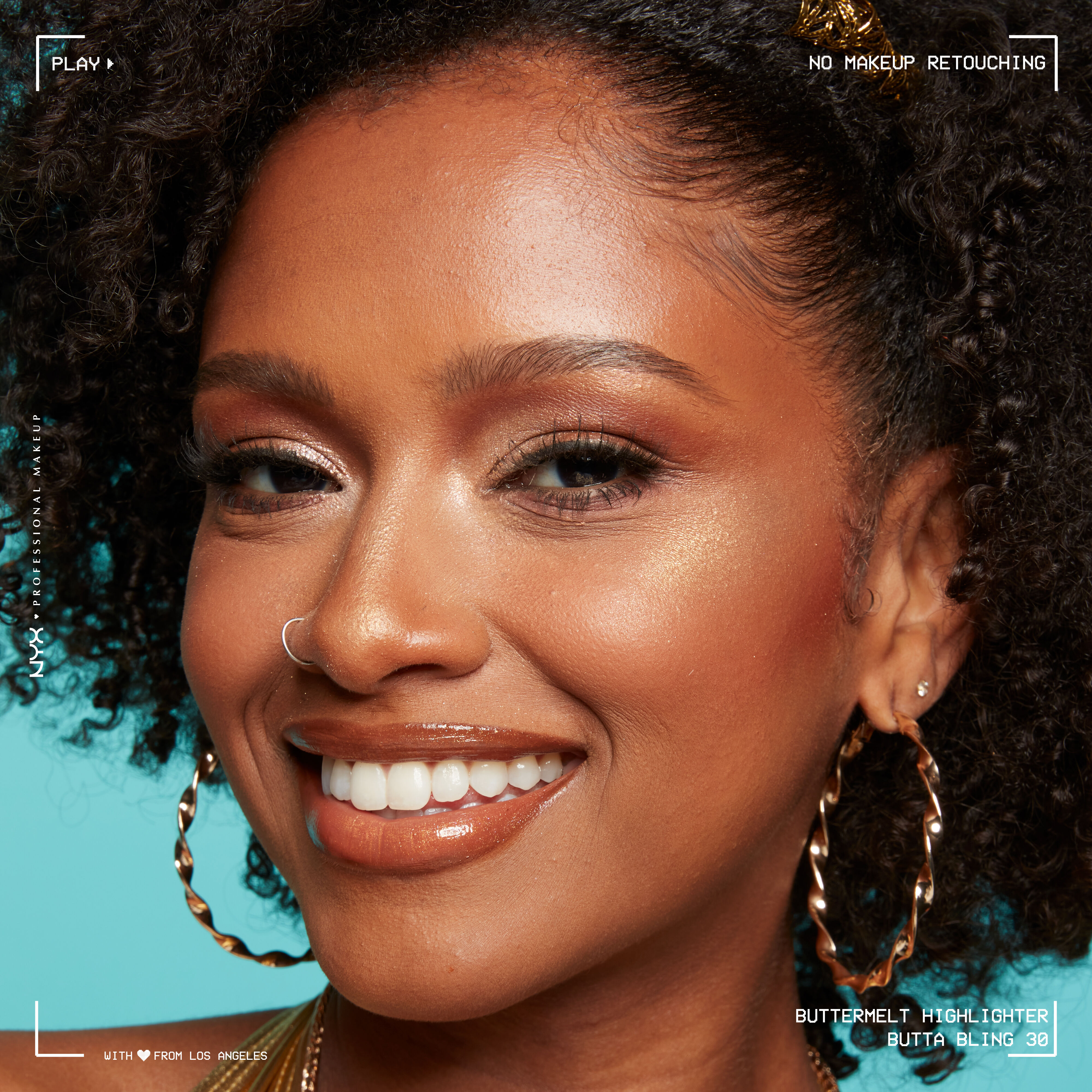 Model looking at the camera and smiling, wearing Buttermelt Highlighter in shade Butta Bling, a light copper shade