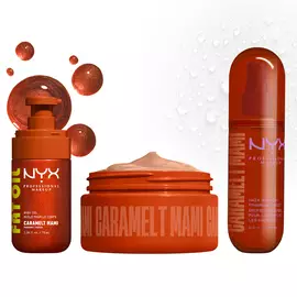 Three NYX Professional Makeup Caramelt Mami products lined up against a light background with caramel brown shimmer bubbles: Fat Oil body oil, body butter in an open brown jar, and hair & body fragrance mist.