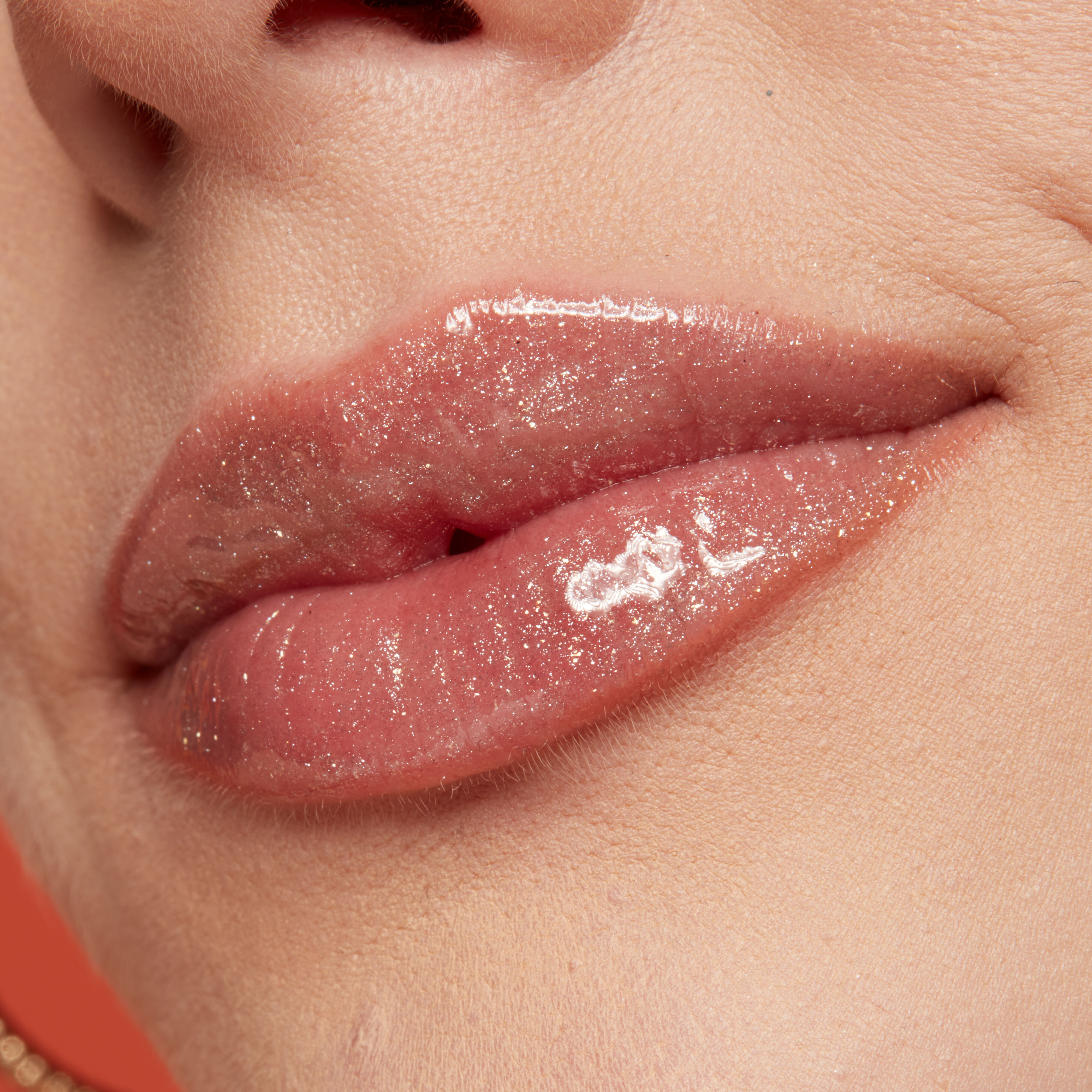 Duck Plump Lip Plumping Gloss on closeup side view of lips