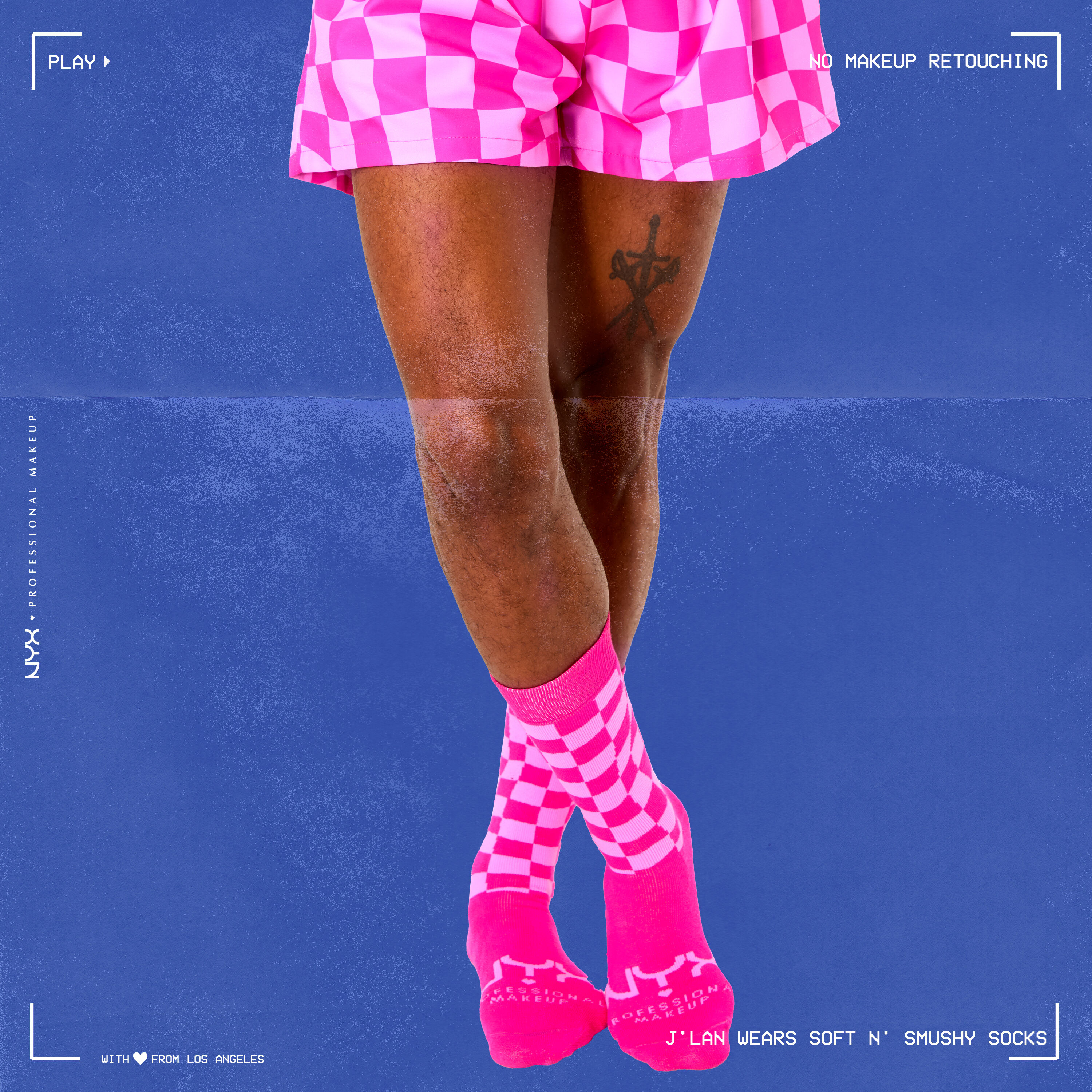 Close-up of model's lower half of body wearing Soft n' Smushy Pink Checker Print Socks and Boxers against a blue background