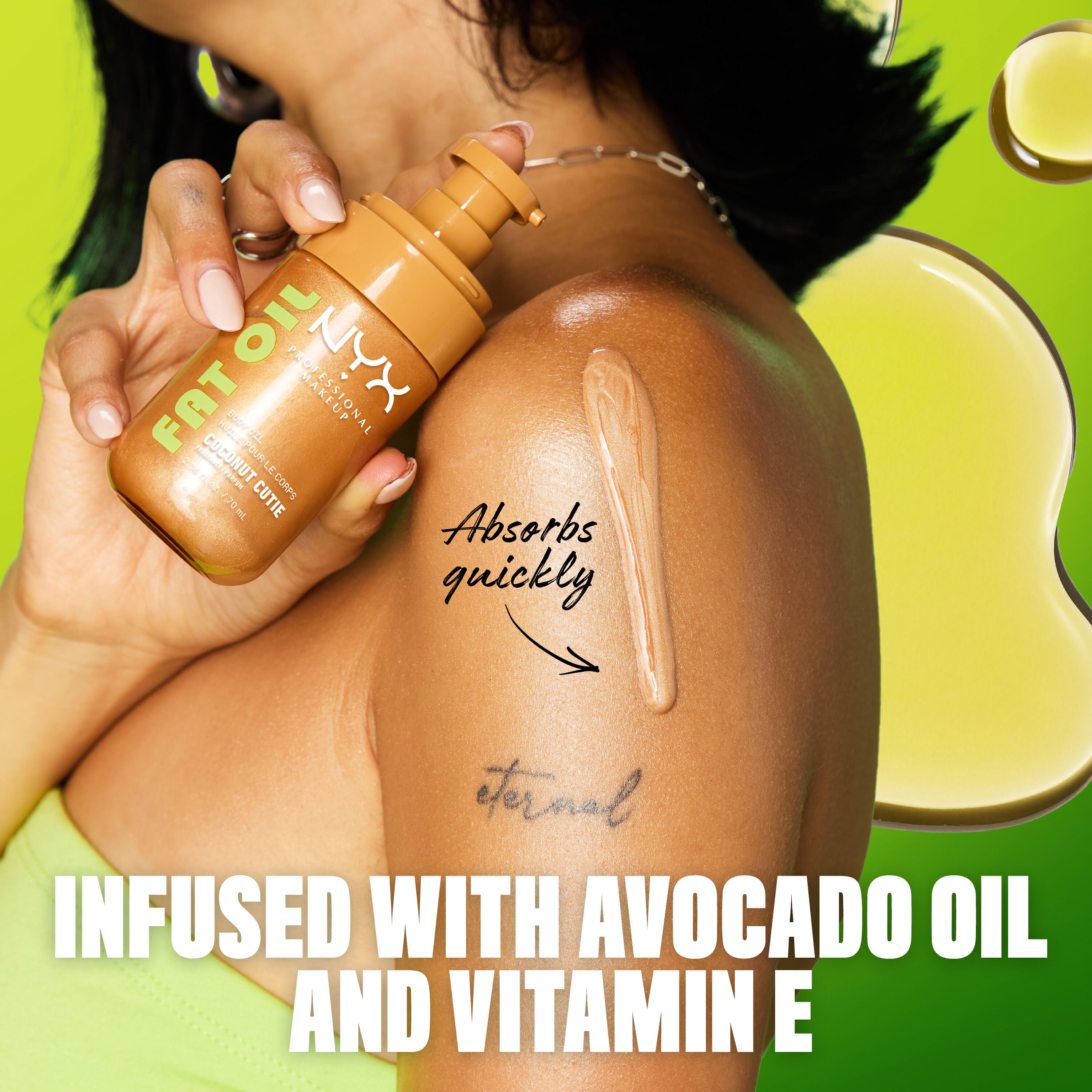 NYX Professional Makeup Body Oil in Coconut Cutie applied to shoulder, showing lightweight texture that absorbs quickly with avocado oil and vitamin E.