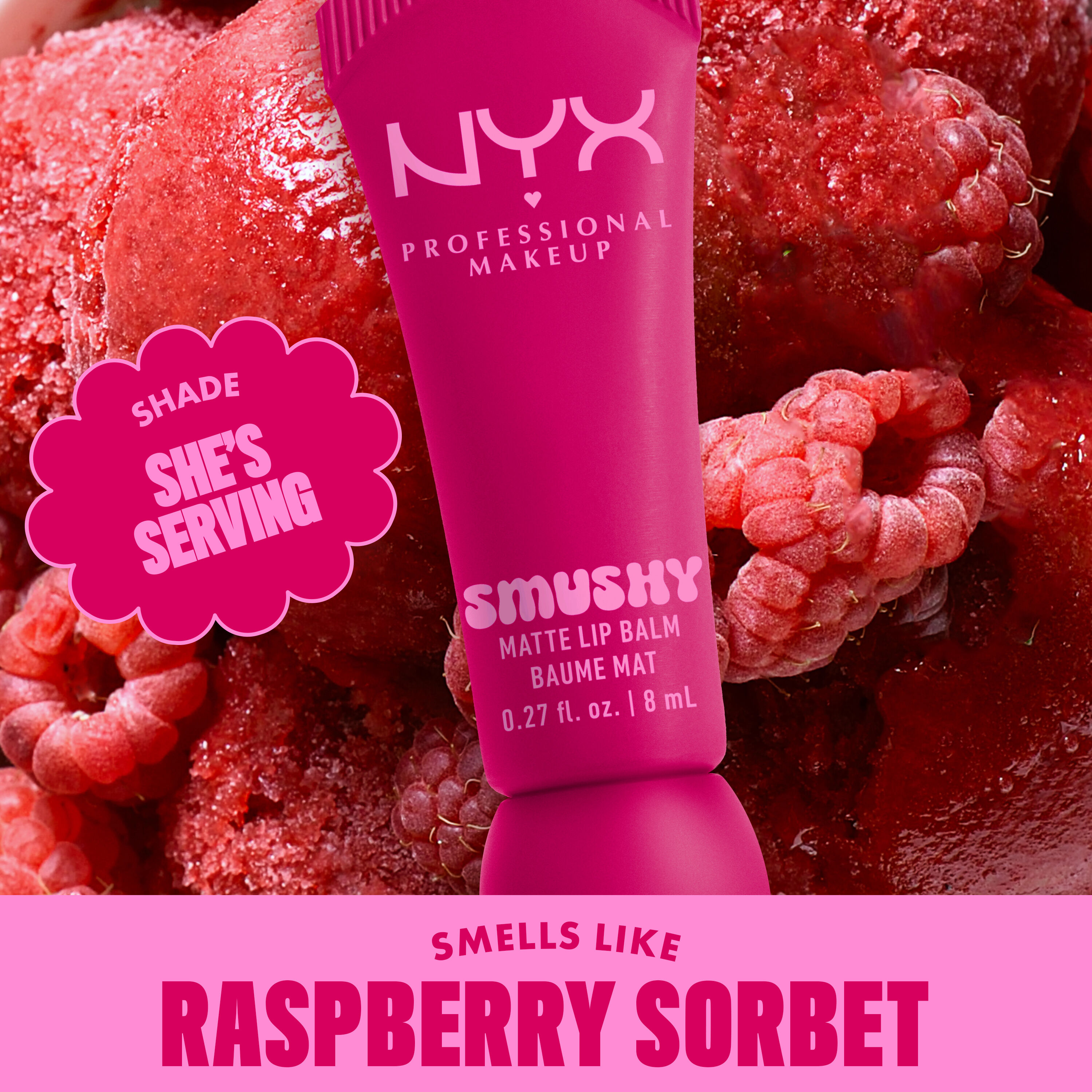 Smushy Matte Lip Balm in fuschia shade She's Serving on raspberries background with text "smells like raspberry sorbet"