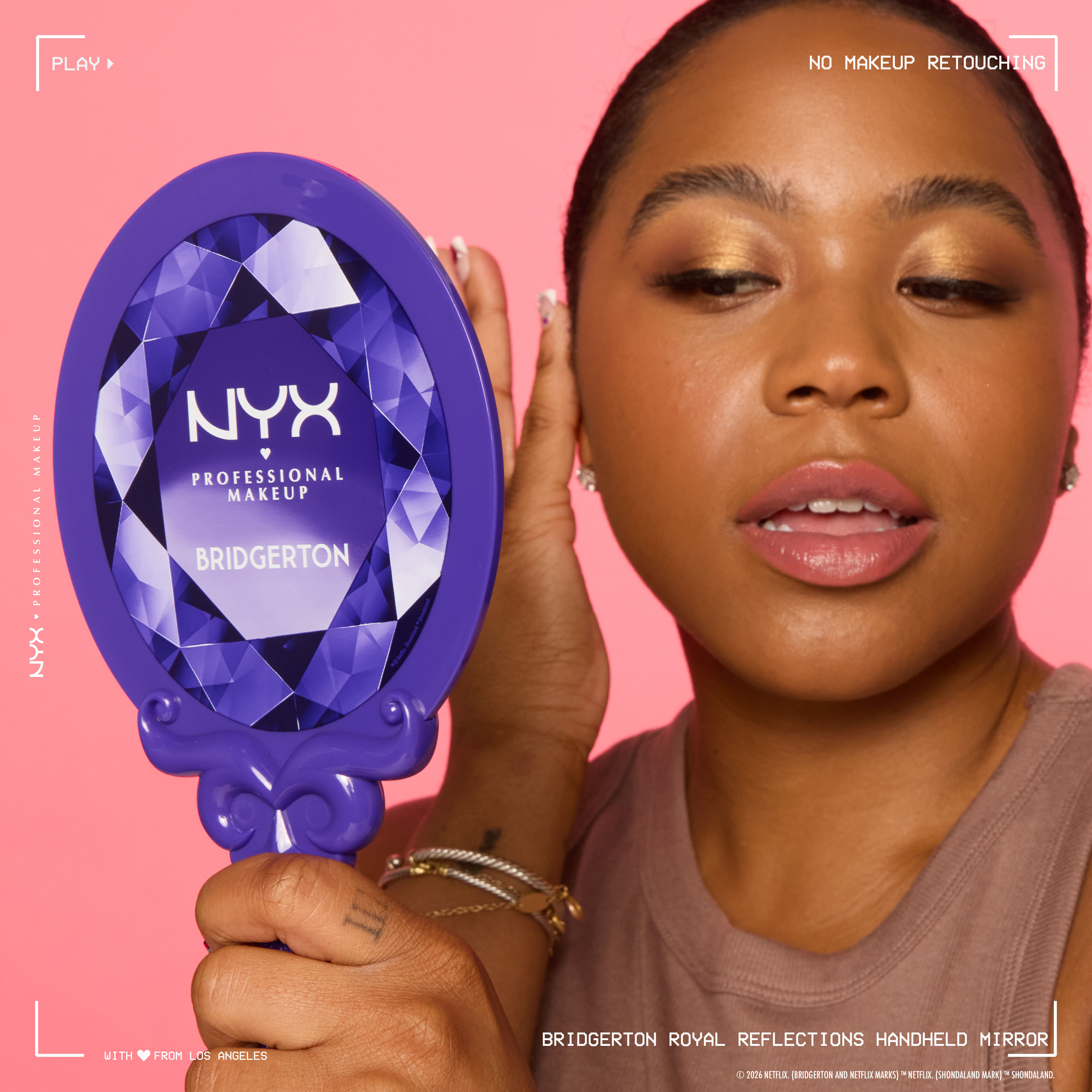 NYX Professional Makeup Bridgerton Royal Reflections Handheld Mirror held in hand, showing ornate purple handle and packaging, excluding blurred face.
