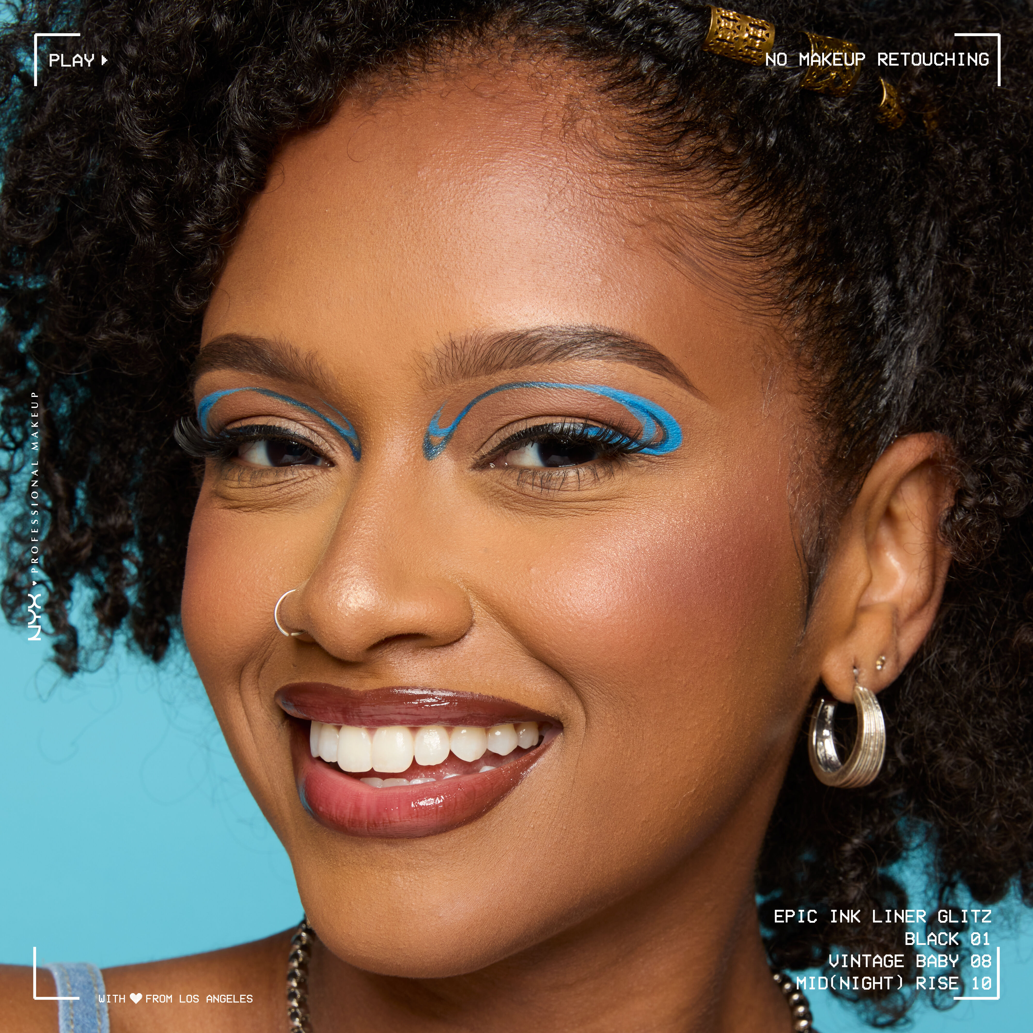 Smiling model wearing graphic liner look with Epic Ink Liquid Liner in Black, Vintage Baby, and Midnight Rise