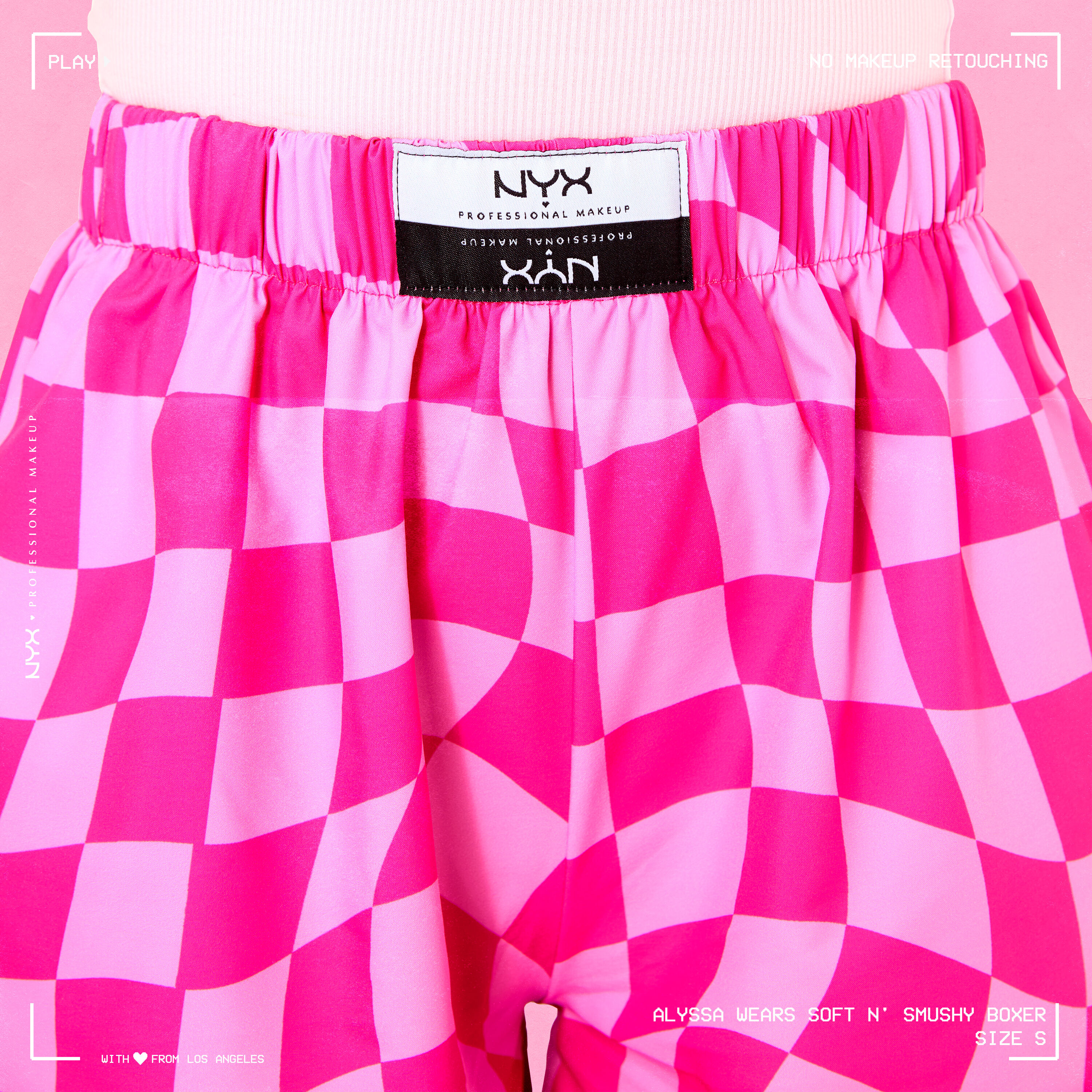 Close up of the front of the Soft n' Smushy Pink Checker Print Boxers, showing the embroidered logo patch in the center