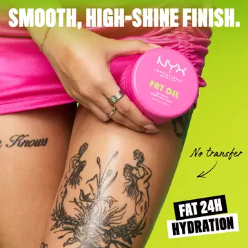 Model in pink skirt with black leg tattoos holding jar of Suga Baddie Body Butter on lime green background. Text at bottom of image: Fat Oil Body.