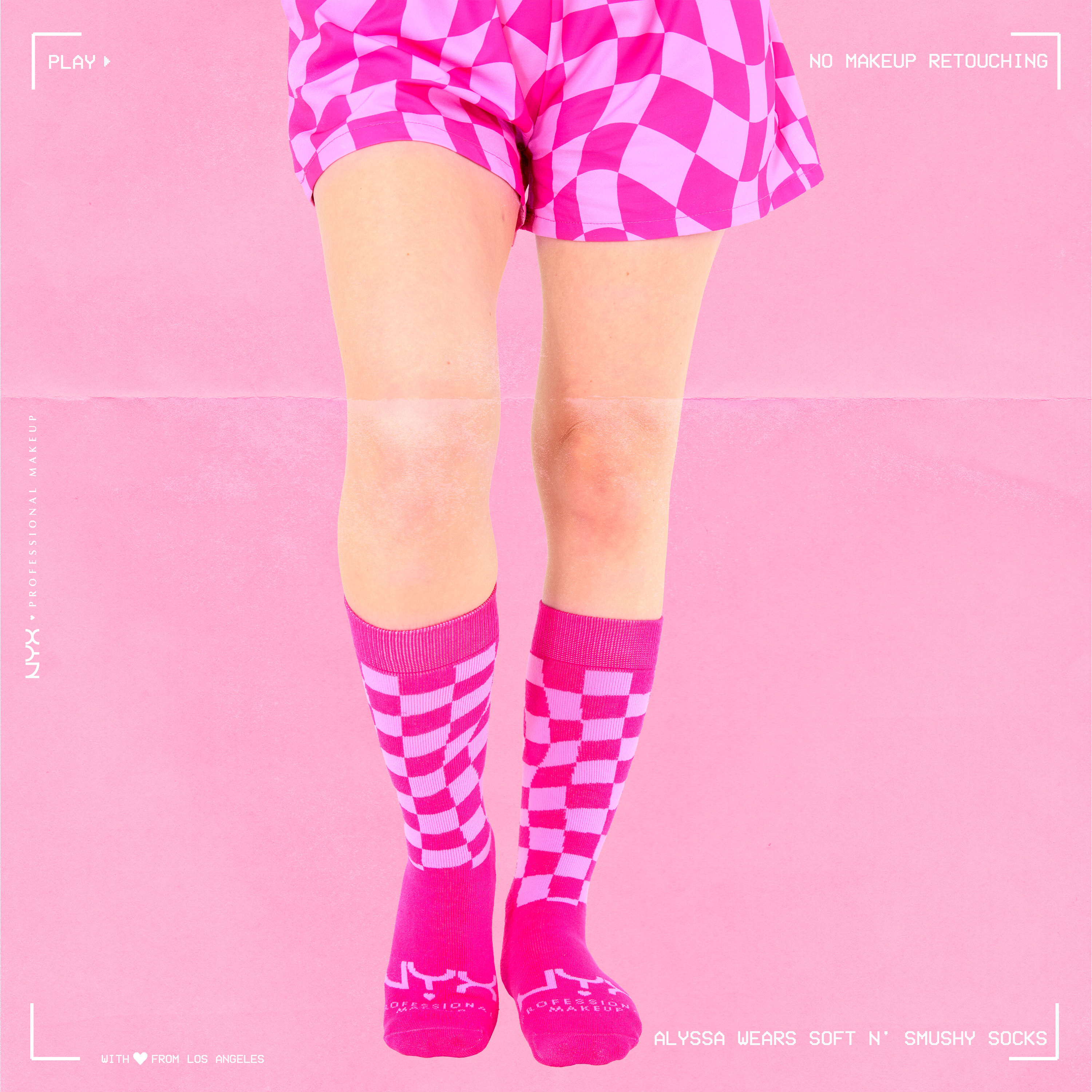 Close-up of model's lower half of body wearing Soft n' Smushy Pink Checker Print Socks and Boxers against a pink background