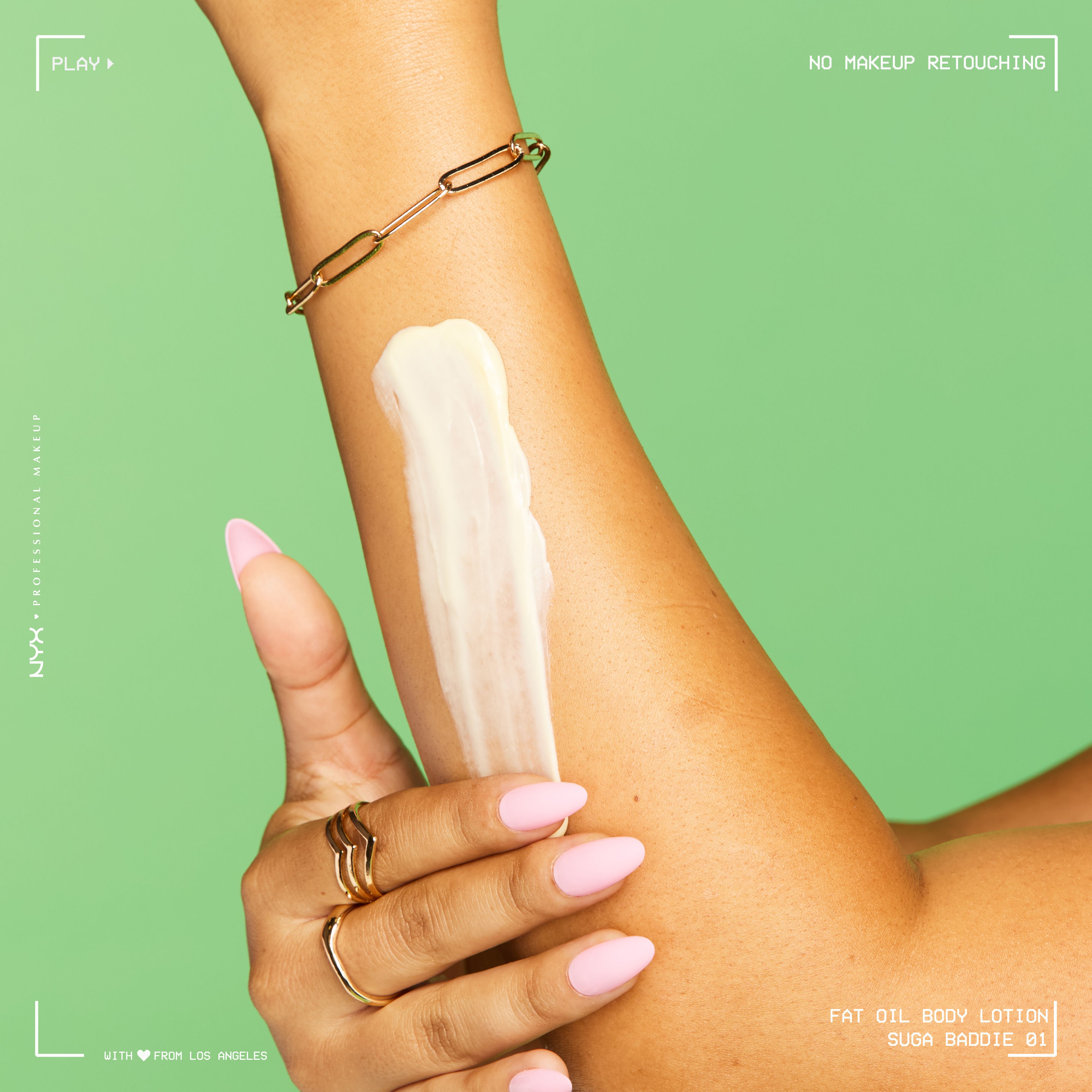 Close-up of an arm with a swipe of lotion being spread across the skin, showing the creamy texture and absorption of the NYX Fat Oil Suga Baddie body lotion.