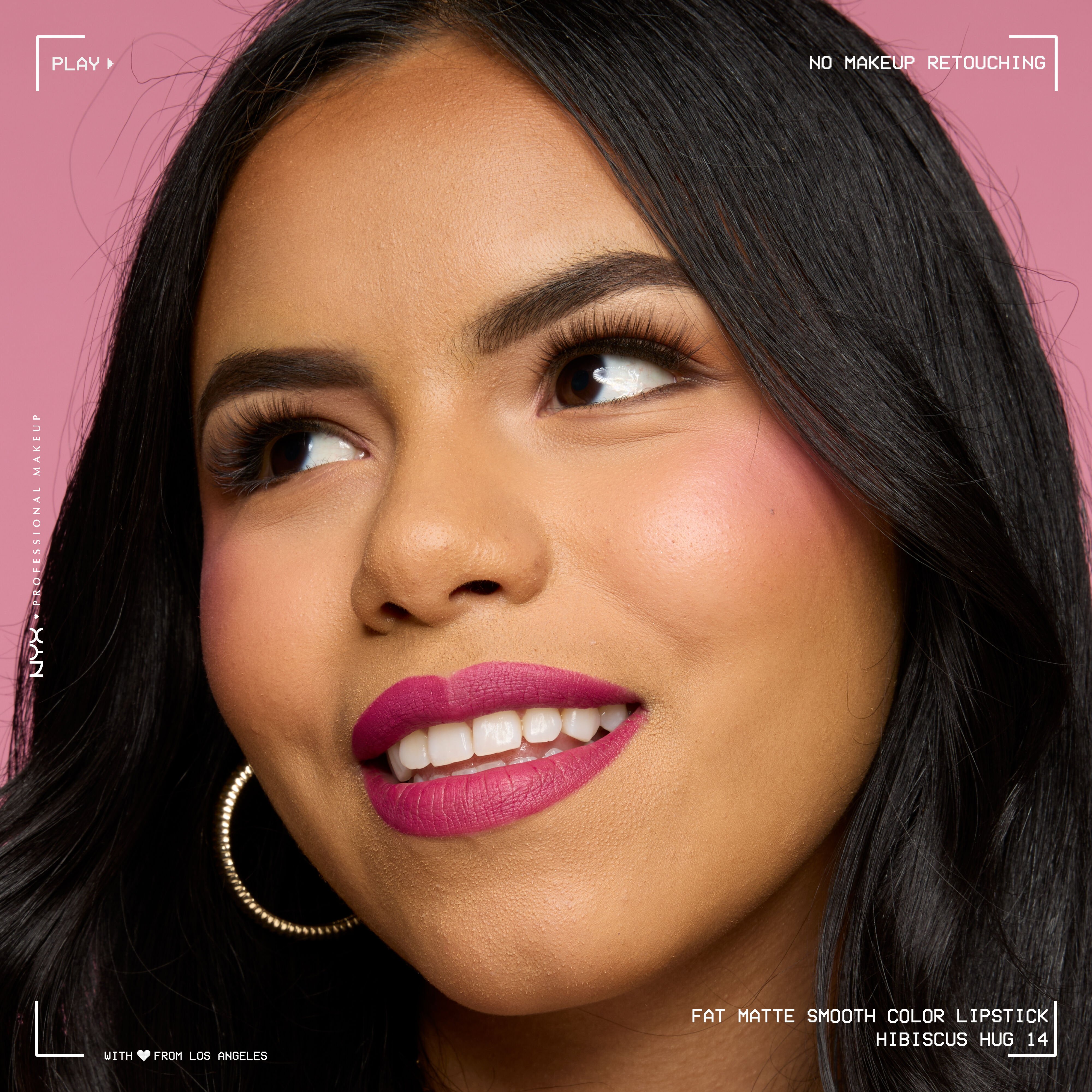 Close-up of model with medium skin tone wearing NYX Professional Makeup Fat Matte Smooth Color Lipstick in Hibiscus Hug, a magenta shade, showing a smooth, non-cakey matte finish. No makeup retouching.