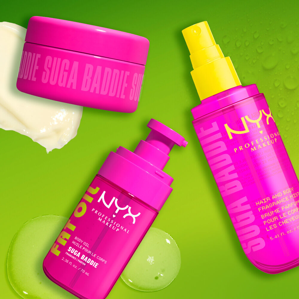 Three bright pink NYX Professional Makeup body care products on a lime green background: Suga Baddie body cream jar, Fat Oil Suga Baddie body oil with pump, and Suga Baddie hair & body fragrance mist with yellow spray pump.