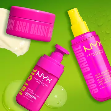 Three bright pink NYX Professional Makeup body care products on a lime green background: Suga Baddie body cream jar, Fat Oil Suga Baddie body oil with pump, and Suga Baddie hair & body fragrance mist with yellow spray pump.