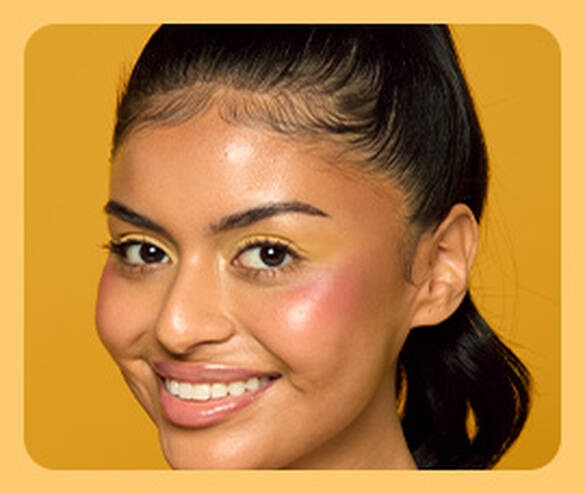 woman smiling and wearing the full Buttermelt product lineup of skin tint, blush, and bronzer