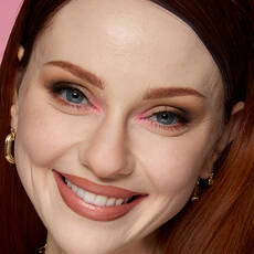 Model wearing NYX Make ’Em Wonder™ Foundation in shade 01 Pale with soft glam and nude lips.