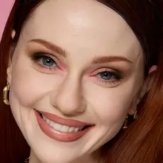 Model wearing NYX Make ’Em Wonder™ Foundation in shade 01 Pale with soft glam and nude lips.