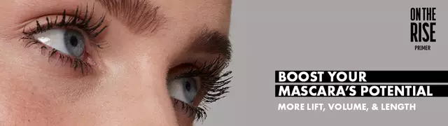 Close-up of model wearing On The Rise Lash primer that boosts mascara's lift, volume, & length