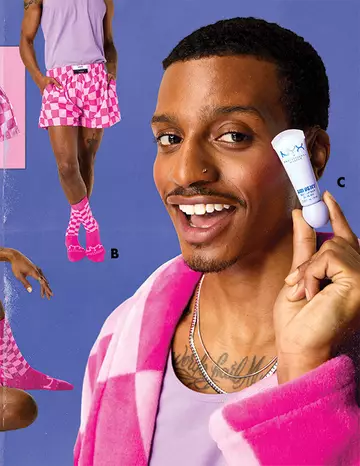 A person wearing pink checkered shorts, socks, and a robe, holding a NYX product.