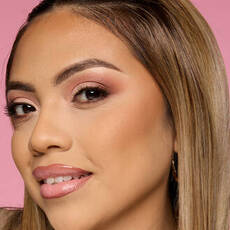 Model wearing NYX Make ’Em Wonder™ Foundation in shade 13 Light Sand with bronze glow and neutral glam look.
