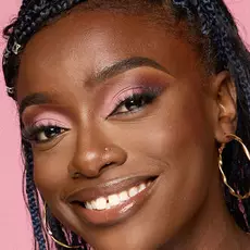 Model wearing NYX Make’em Wonder™ Foundation in shade 41 Warm Walnut with soft glow and pink shimmer eyeshadow.