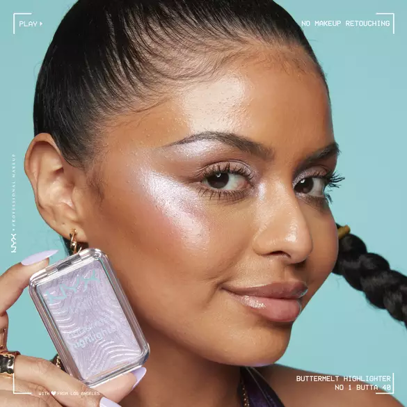 Model holding and wearing Buttermelt Highlighter in shade No 1 Butta, a holographic lavender highlighter shade