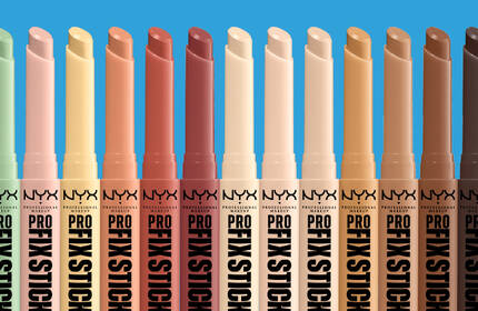 NYX Professional Makeup Pro Fix Sticks in a range of corrective concealer shades displayed against a blue background.