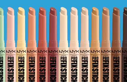NYX Professional Makeup Pro Fix Sticks in a range of corrective concealer shades displayed against a blue background.