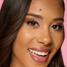 Model wearing NYX Make ’Em Wonder™ Foundation in shade 24 Golden with radiant finish and glossy lips.