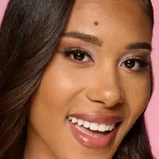 Model wearing NYX Make ’Em Wonder™ Foundation in shade 24 Golden with radiant finish and glossy lips.