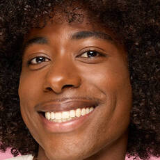 Model wearing NYX Make ’Em Wonder™ Foundation in shade 37 Deep Rich with natural matte finish and smooth glow.