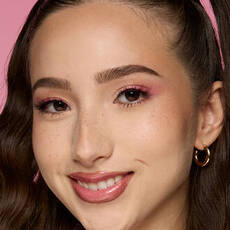 Model wearing NYX Make ’Em Wonder™ Foundation in shade 08 Vanilla with soft pink eyeshadow and natural glow.