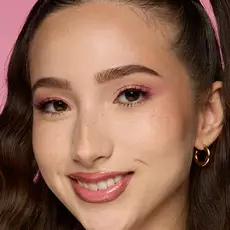 Model wearing NYX Make ’Em Wonder™ Foundation in shade 08 Vanilla with soft pink eyeshadow and natural glow.