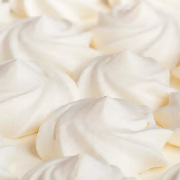 Close-up shot of whipped cream to represent one of the top notes in Suga Baddie fragrance.