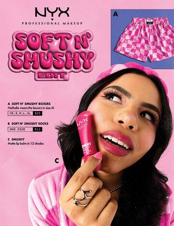 A promotional image for NYX Professional Makeup's "Soft N' Shushy Edit," featuring pink checkered boxers, socks, and a person holding a NYX Soft Matte Lip Cream in pink packaging.