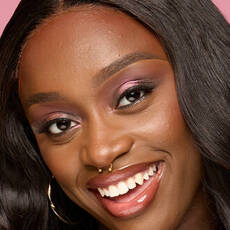 Model wearing NYX Make ’Em Wonder™ Foundation in shade 39 Cocoa with luminous finish and pink shimmer eye look.