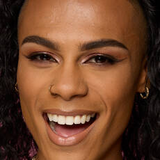 Model wearing NYX Make ’Em Wonder™ Foundation in shade 23 Golden Caramel with bronzed glow and soft glam.