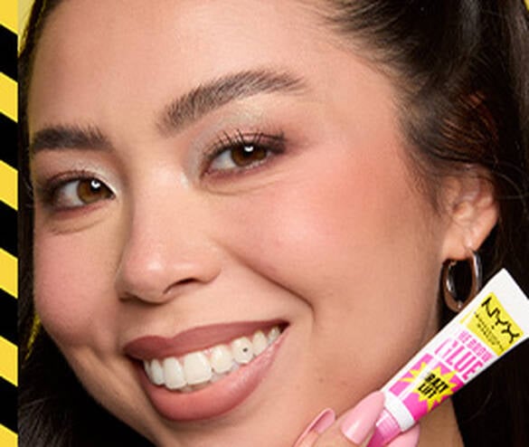Model with lifted and laminated brows smiling and posing with The Brow Glue Crazy Lift