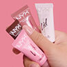 5-second reel showing a hand holding four NYX Professional Makeup Lid Lingerie Eye Pigment tubes against a pink background, then showing application and final look.