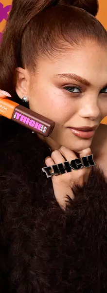 Model holding NYX Rithickulous Brow Volume Mousse