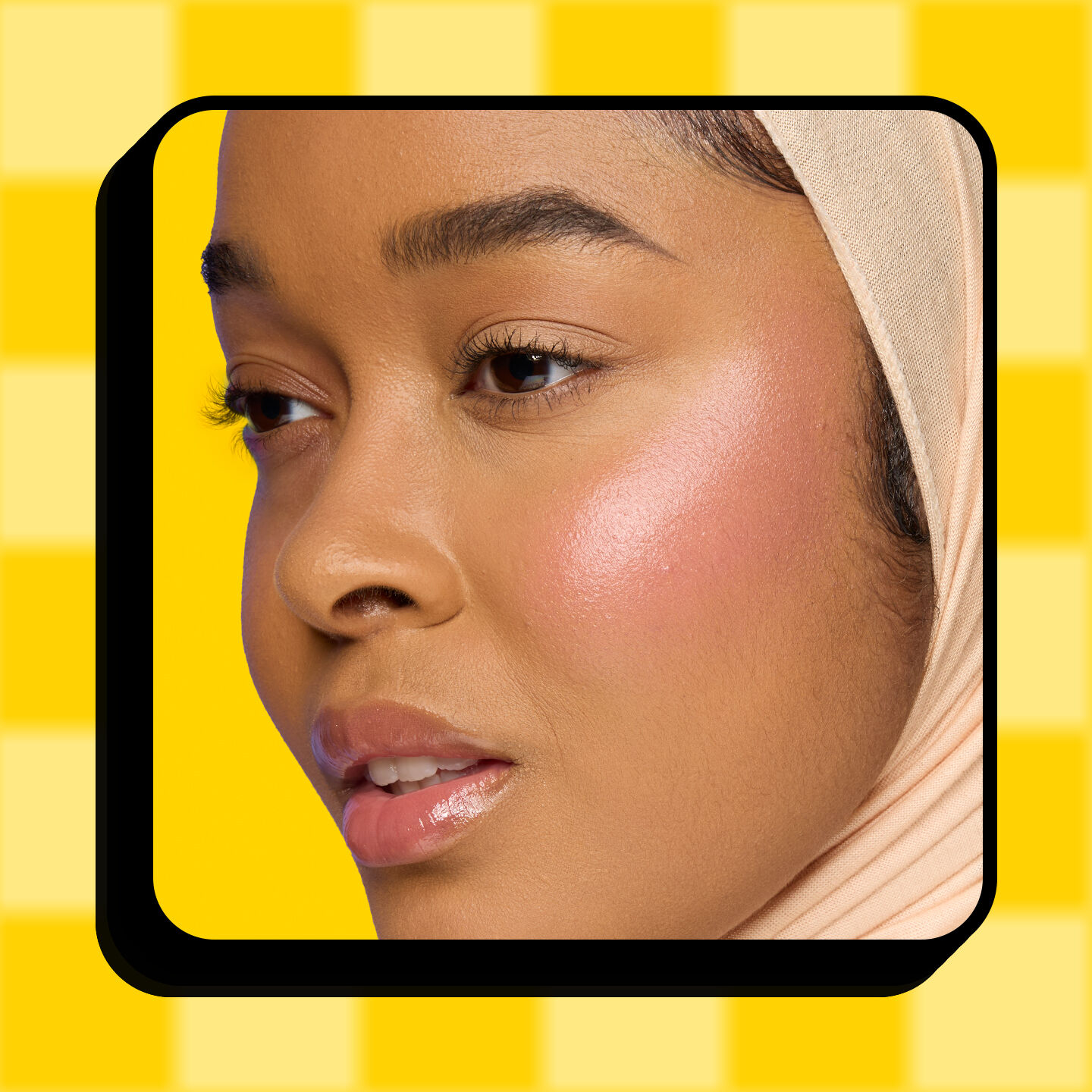 NYX Professional Makeup Saucy Sisters' Fat Cheeks Blush in shade 01 Snarky Scarlet, product displayed on a yellow checkered background.