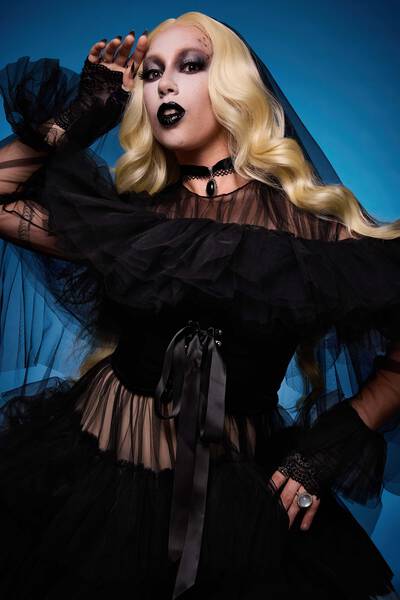 Zombie-inspired Halloween makeup look with fake scars, skeleton teeth, and under-eye shadows