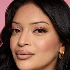 Model wearing NYX Make ’Em Wonder™ Foundation in shade 11 Classic Ivory with soft contour and pink shimmer eyes.