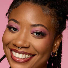 Model wearing NYX Make ’Em Wonder™ Foundation in shade 33 Sienna with radiant glow and pink eyeshadow.