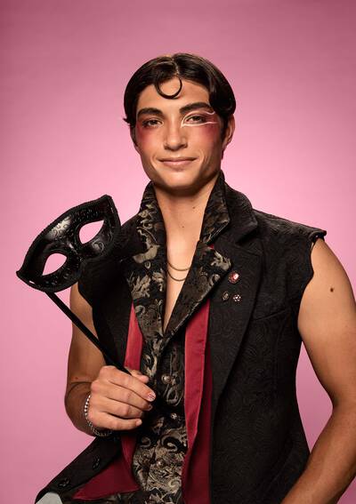 Dracula-inspired Halloween makeup look, with dripping red lip and bat wing detailed eye look