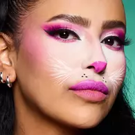 NYX Professional Makeup pink cat Halloween look with pink eye makeup, a pale muzzle, whisker details and bright pink lips.