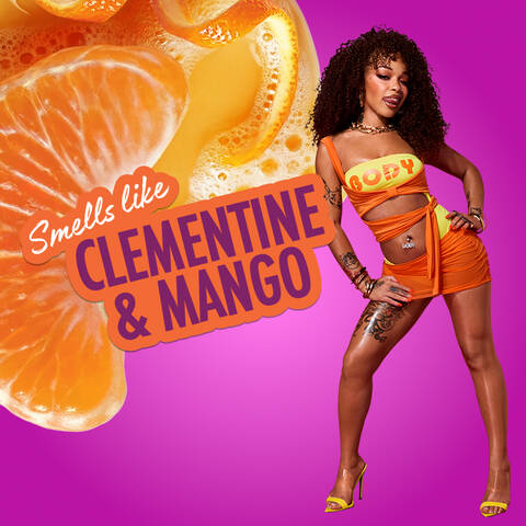 Orange citrus splash with a sliced clementine on a magenta background, with text reading Smells like Clementine & Mango for the Juicy Boo scent by NYX Professional Makeup Body Collection.