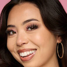 Model wearing NYX Make ’Em Wonder™ Foundation in shade 09 Light Nude with radiant glow and glam lashes.